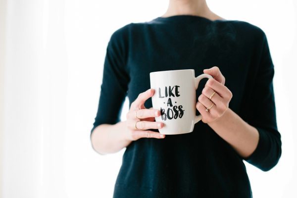 woman-holding-white-mug-while-standing